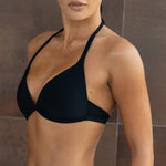 Black plunge bikini top with halter neckline and ribbed texture on model.