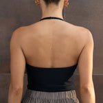 Black halter top with plunging neckline, shown from back view on model.