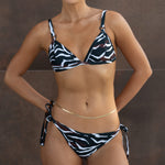 Triangle bikini top with black and white zebra stripe pattern and adjustable shoulder straps.